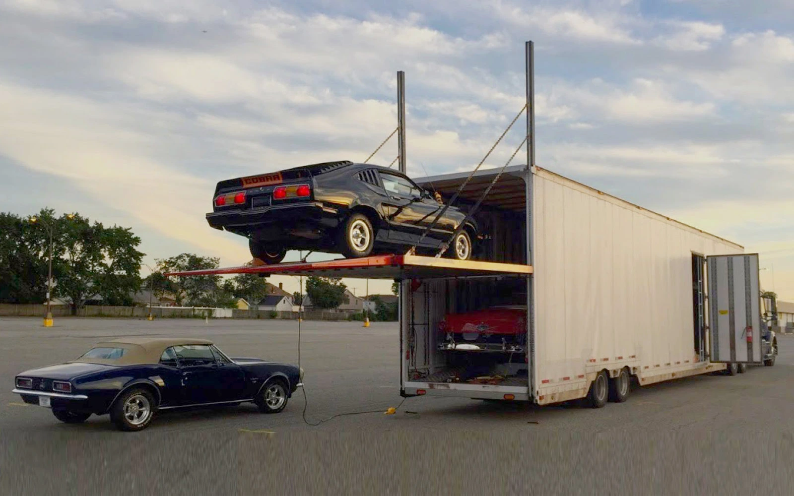 AutosMover fleet vehicles being loaded for transport